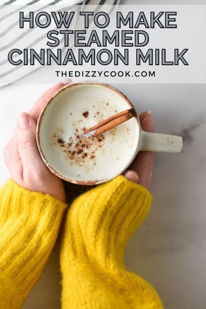 Two hands holding a cup of warm cinnamon milk