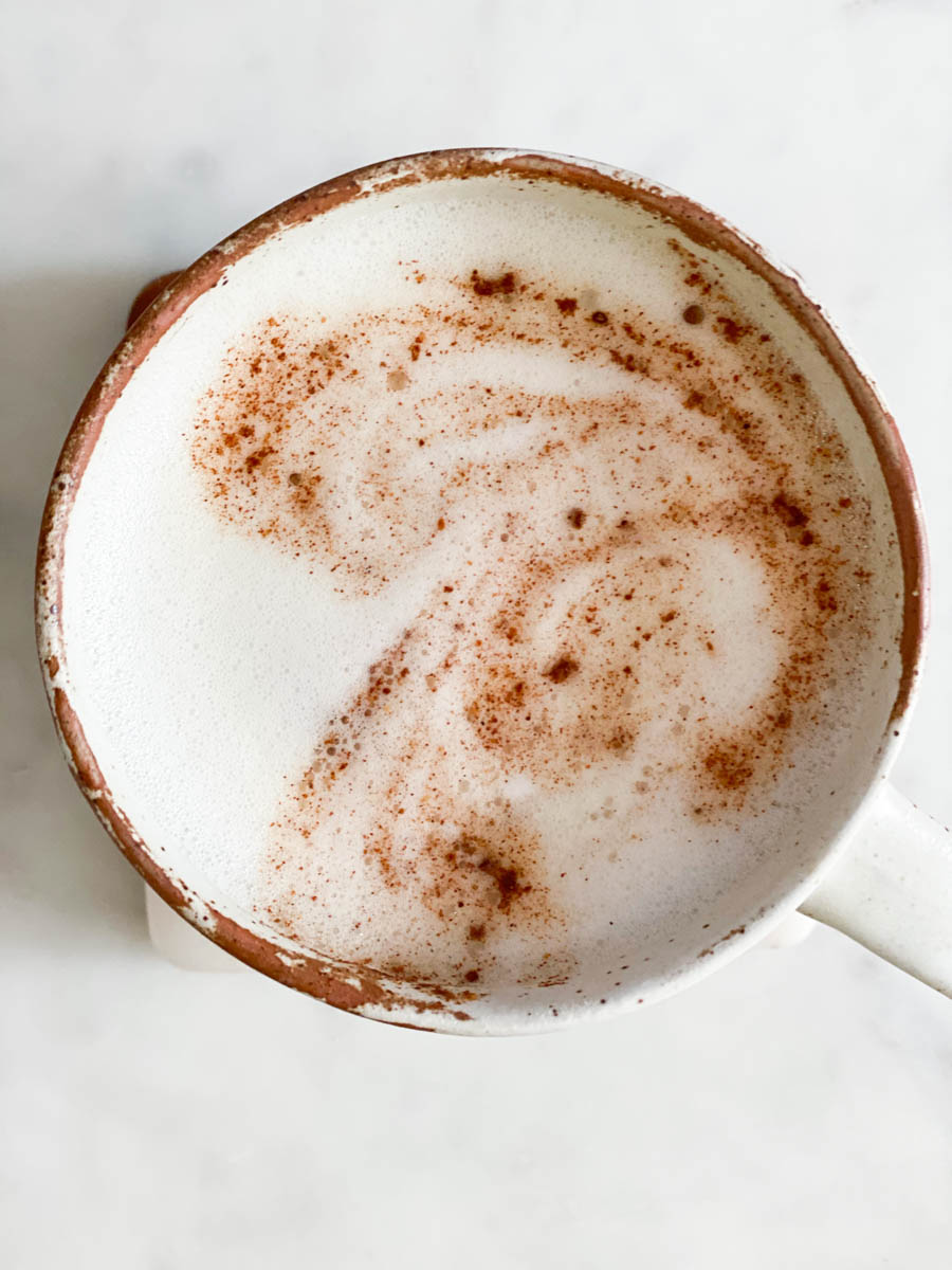 A cinnamon design of a butterfly in steamed milk