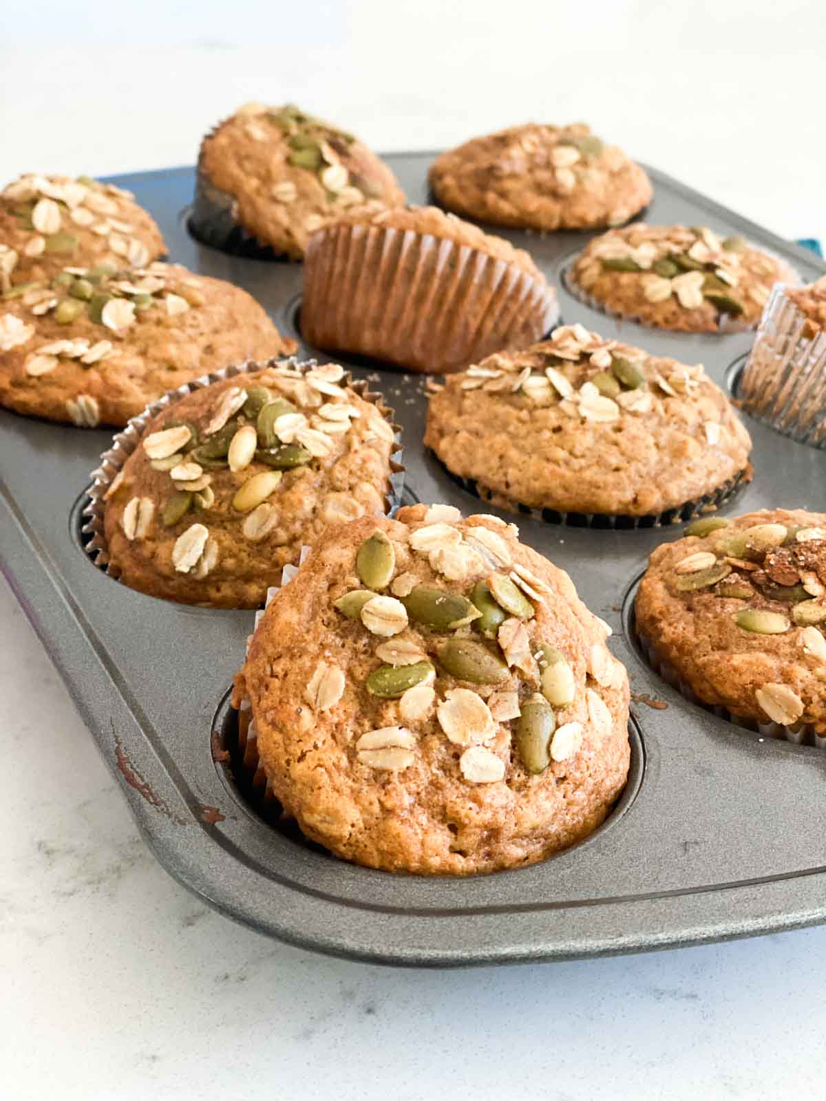 Oatmeal muffins in a pan just removed from the oven.