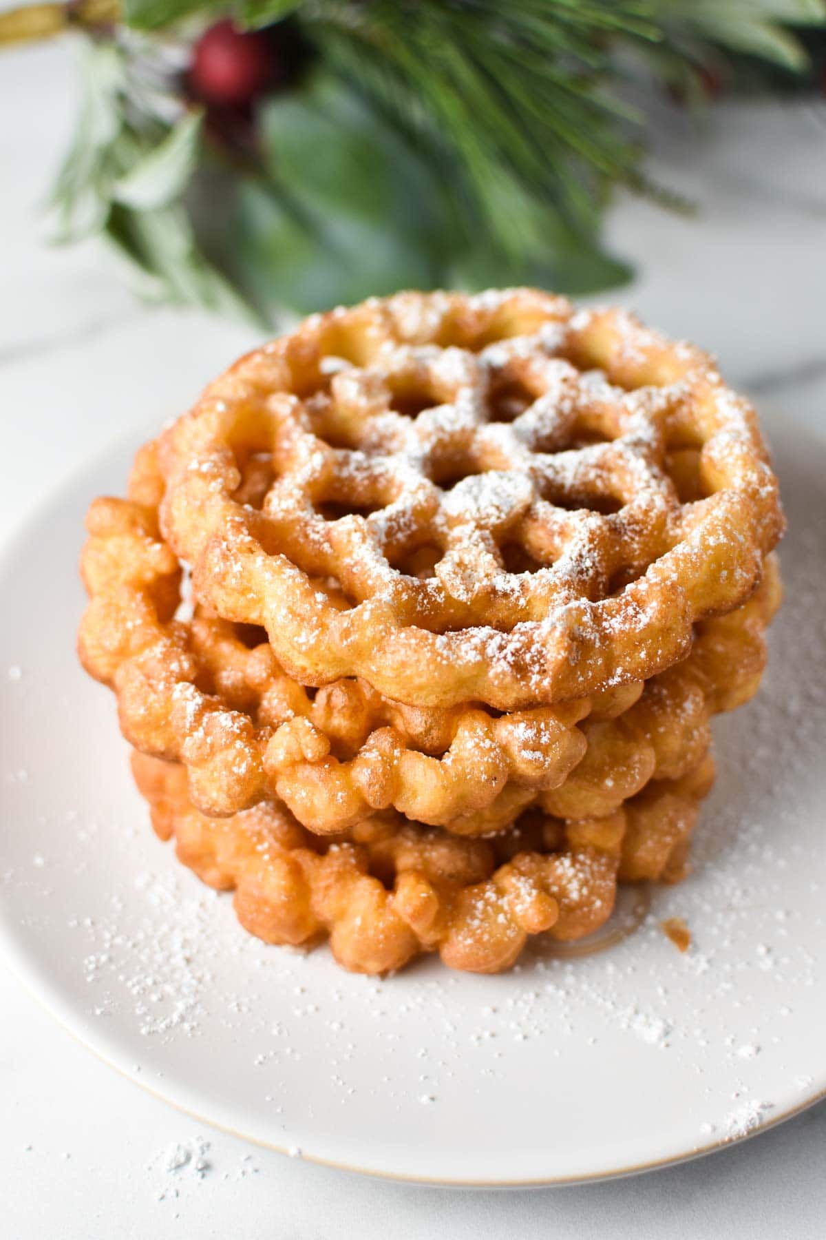 A stack of fried cookies in a snowflake pattern