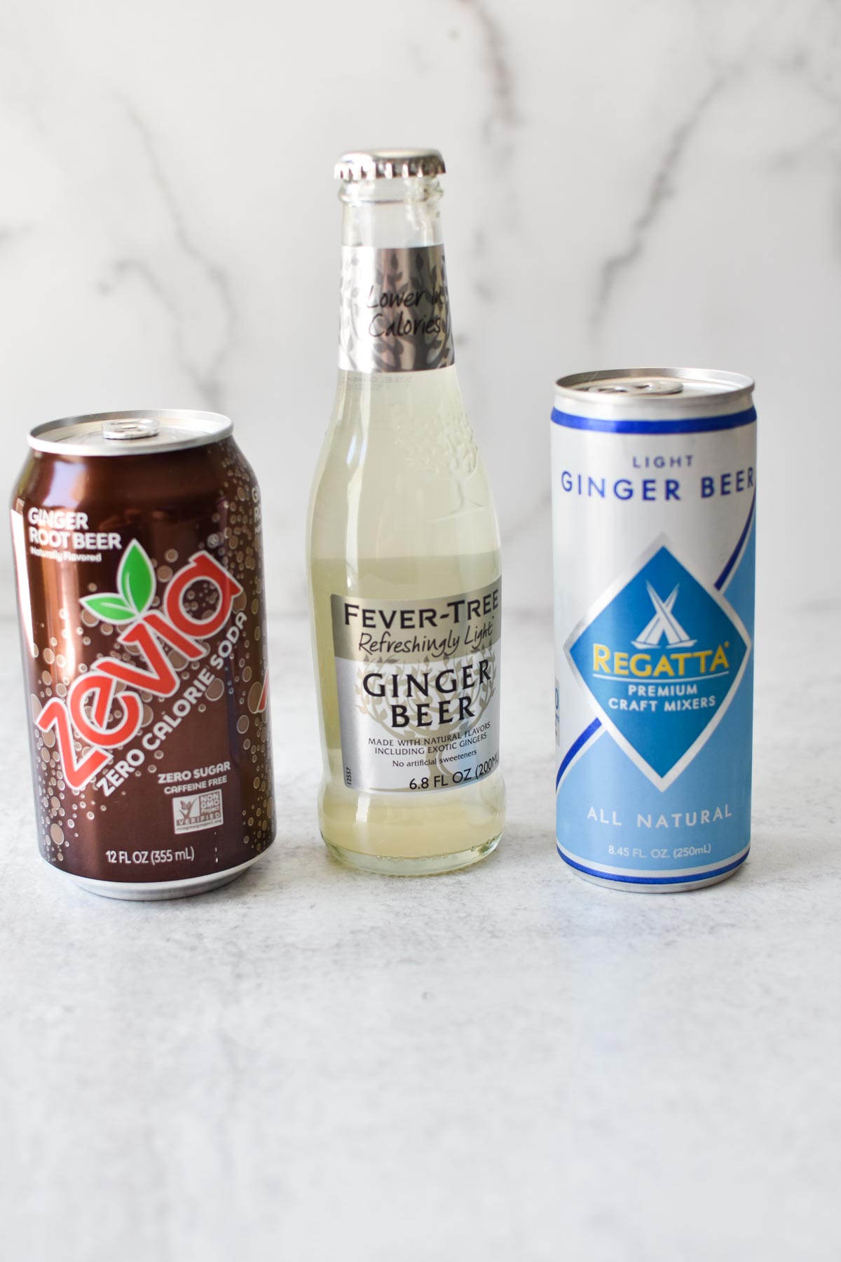 A bunch of ginger beers on a marble table