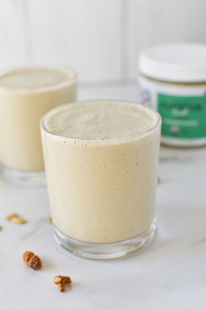 Two seed smoothies next to a jar of pumpkin seed butter