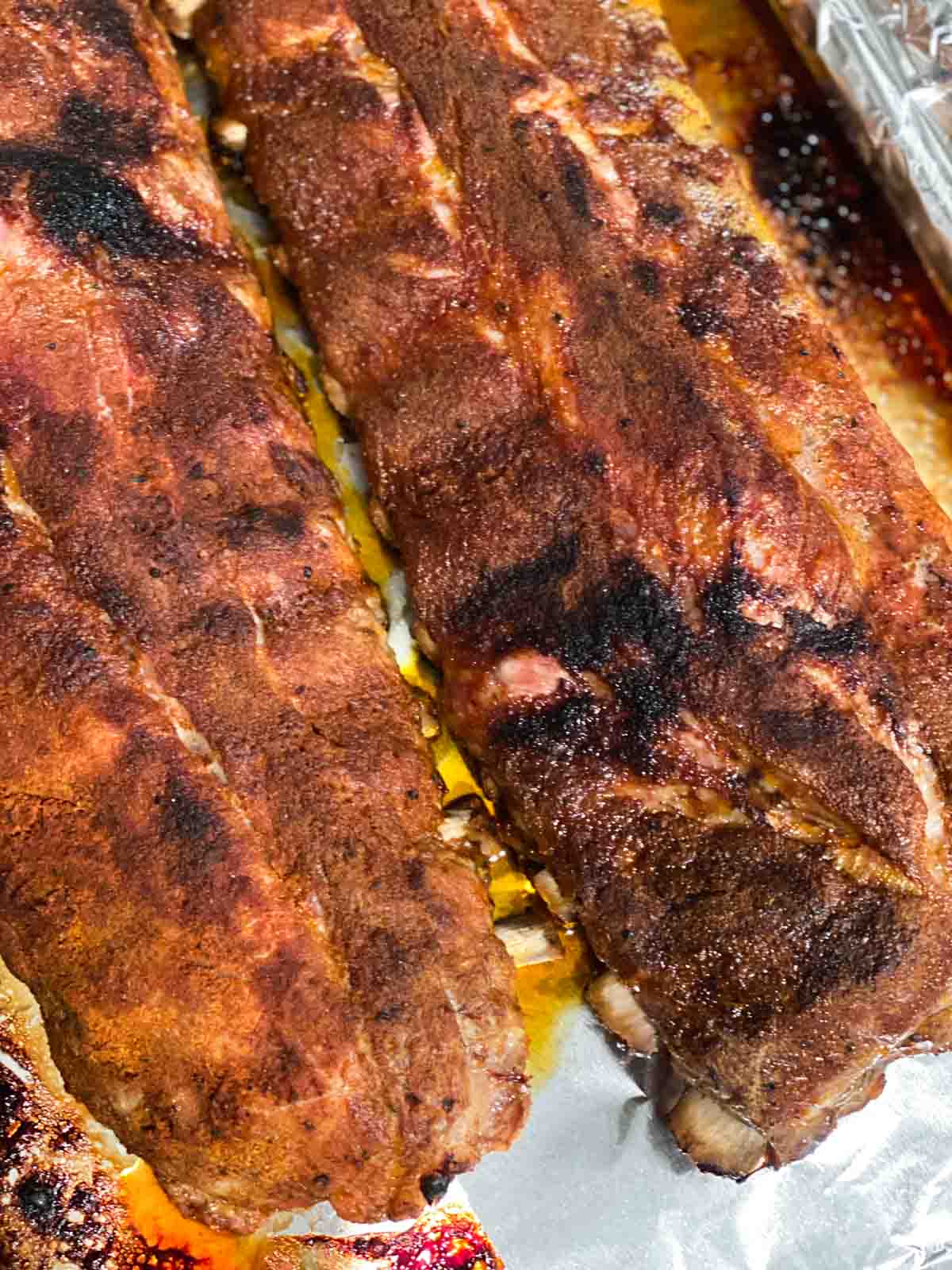 Two racks of ribs after being broiled in the oven