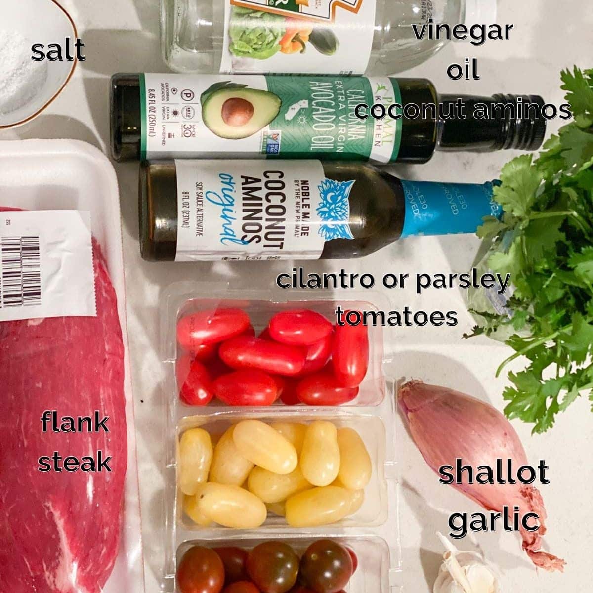 Ingredients for flank steak marinade like coconut aminos, shallots, garlic, and parsley.