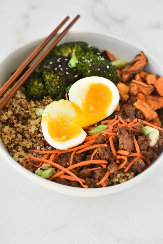 Ground beef, broccoli, carrots, and quinoa topped with a jammy egg