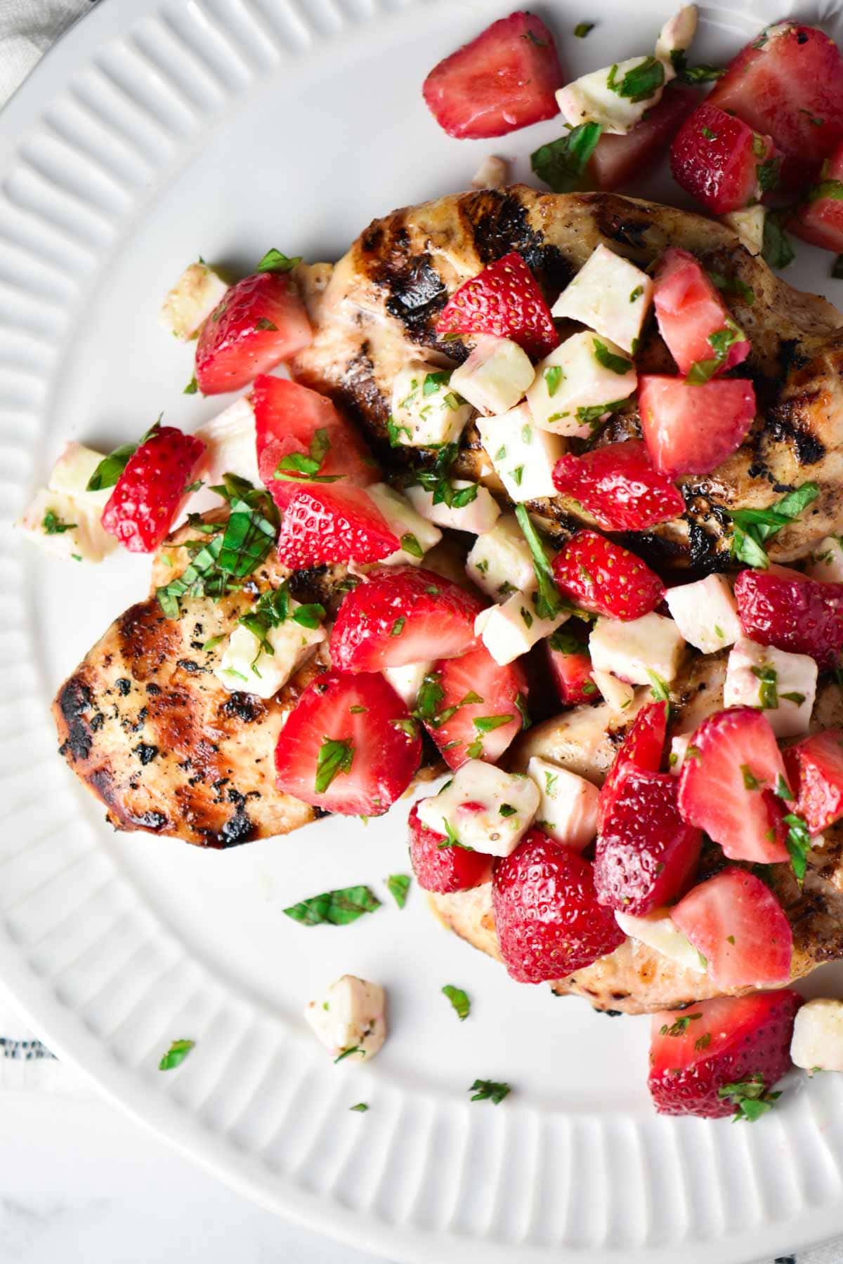 Grilled chicken topped with a strawberry mozzarella relish