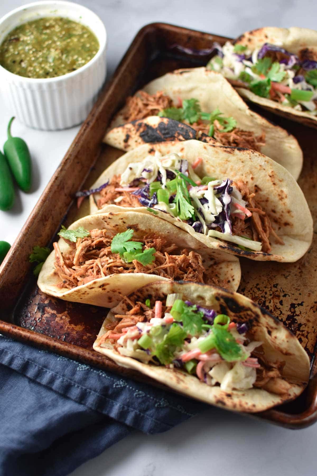 Chicken tinga topped with cilantro and slaw