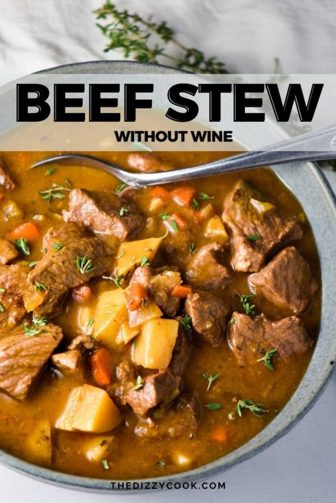 A bowl of beef stew with a spoon digging in