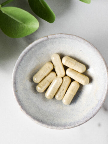 A bowl of l tryptophan supplements on a white table
