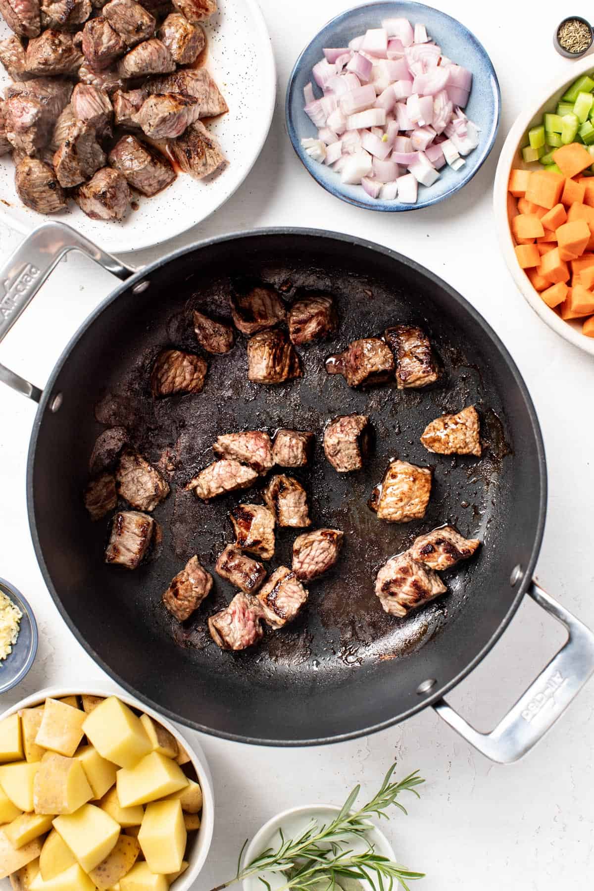 Seared beef chuck roast in a large simmer pot.