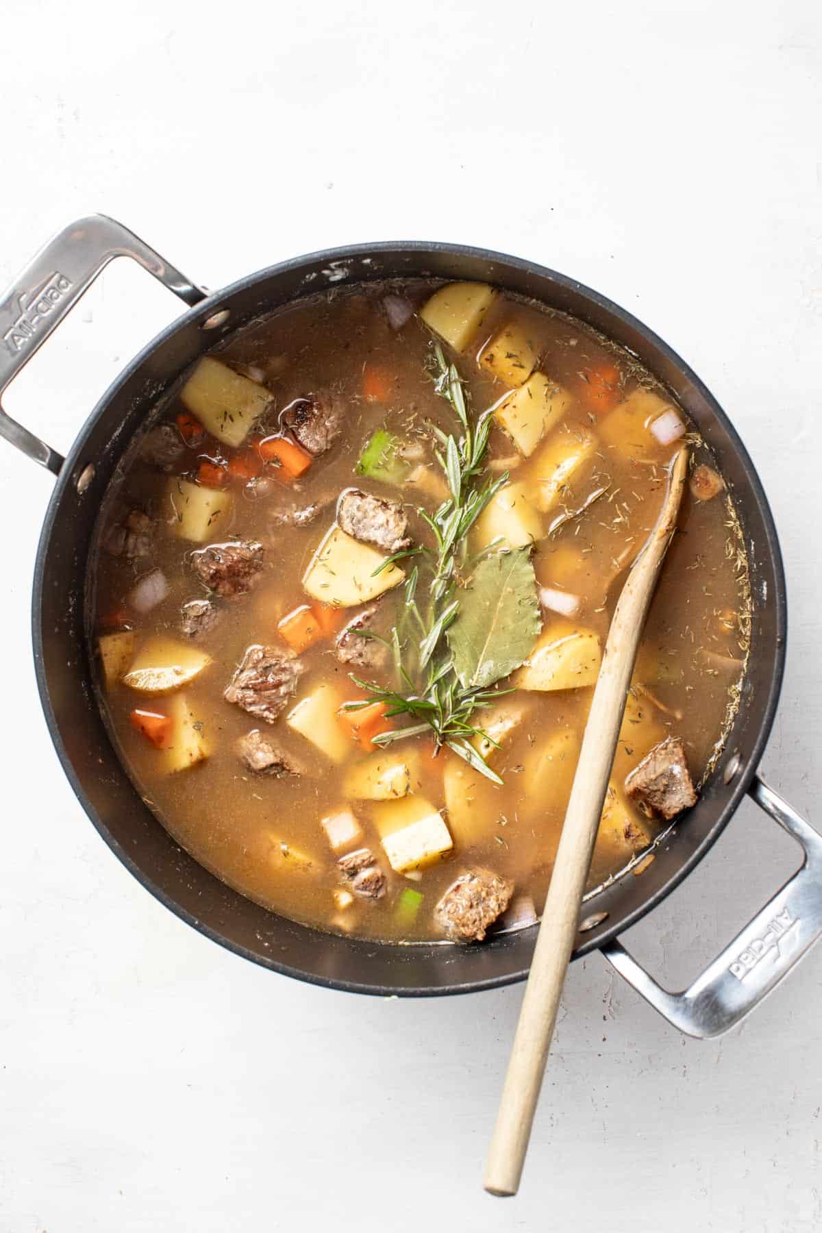 Beef stew with broth before simmering.