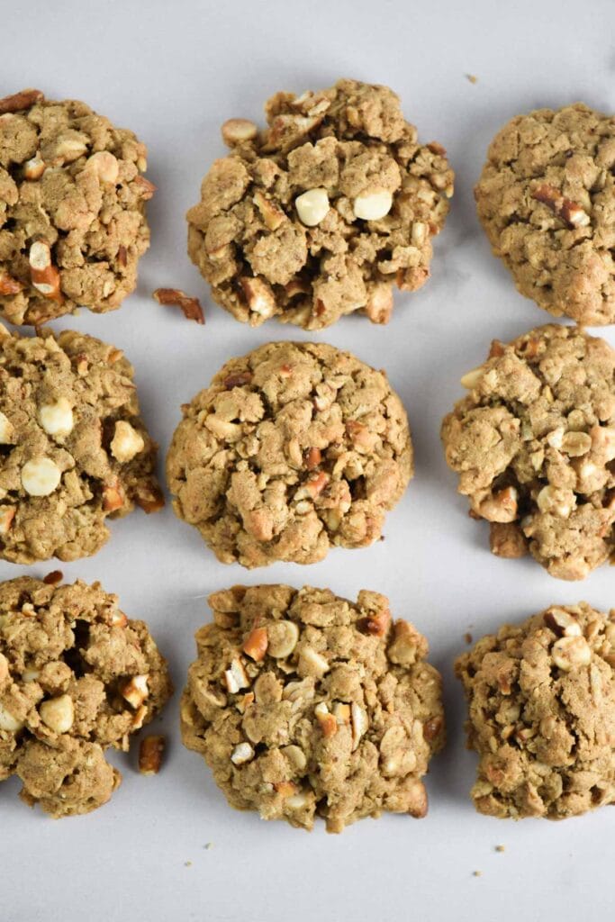 Nine white chocolate oatmeal cookies on a white table