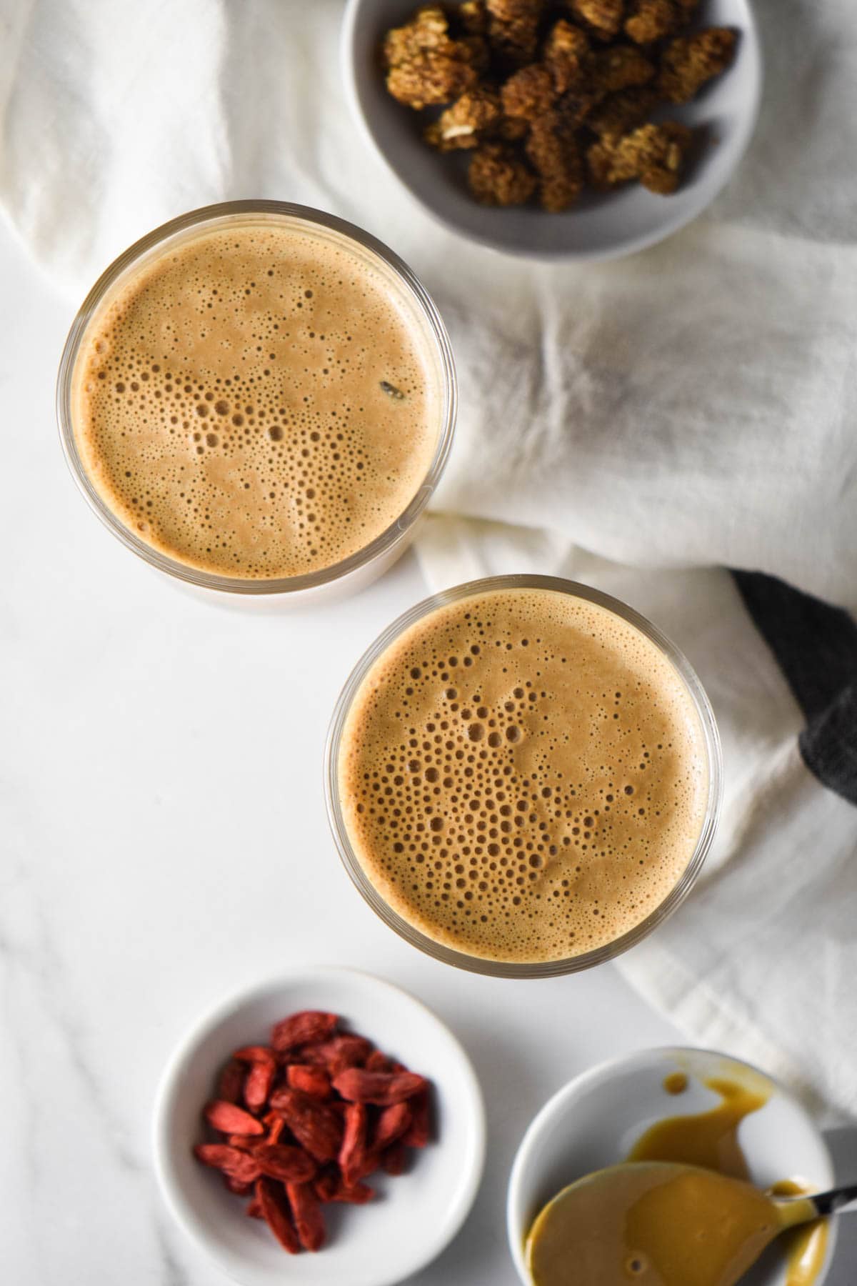 Two smoothies next to goji berries