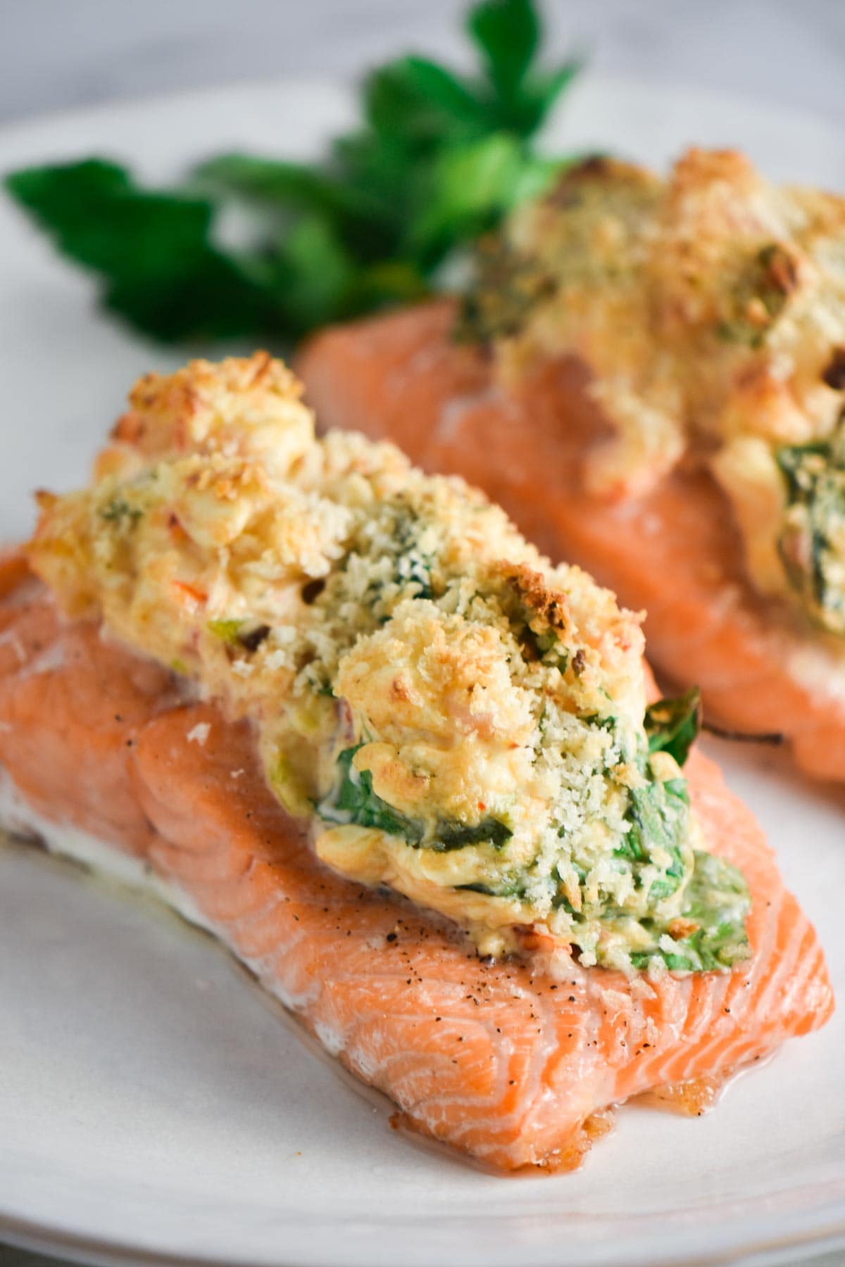 Two baked salmon fillets stuffed with spinach and shrimp.