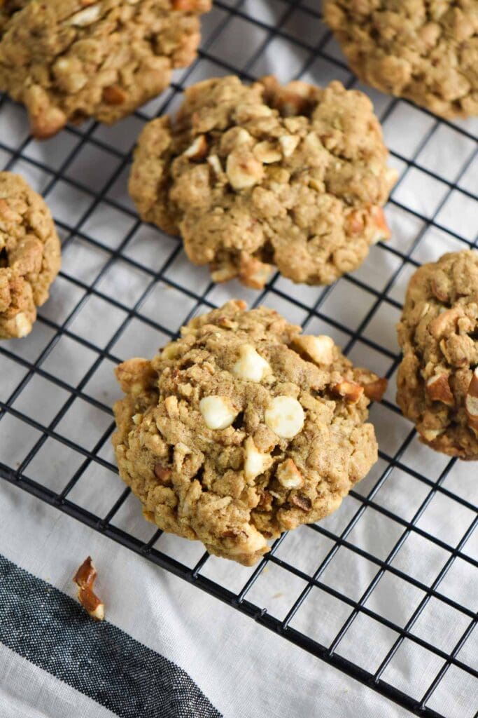 A white chocolate cookie on a metal rack