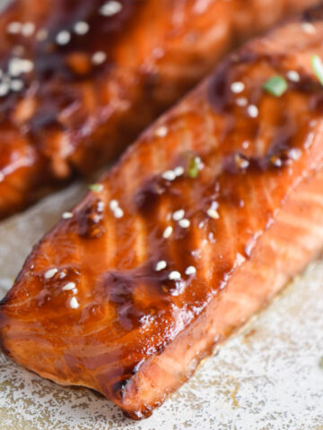 Air fryer teriyaki salmon fillets on a speckled plate.