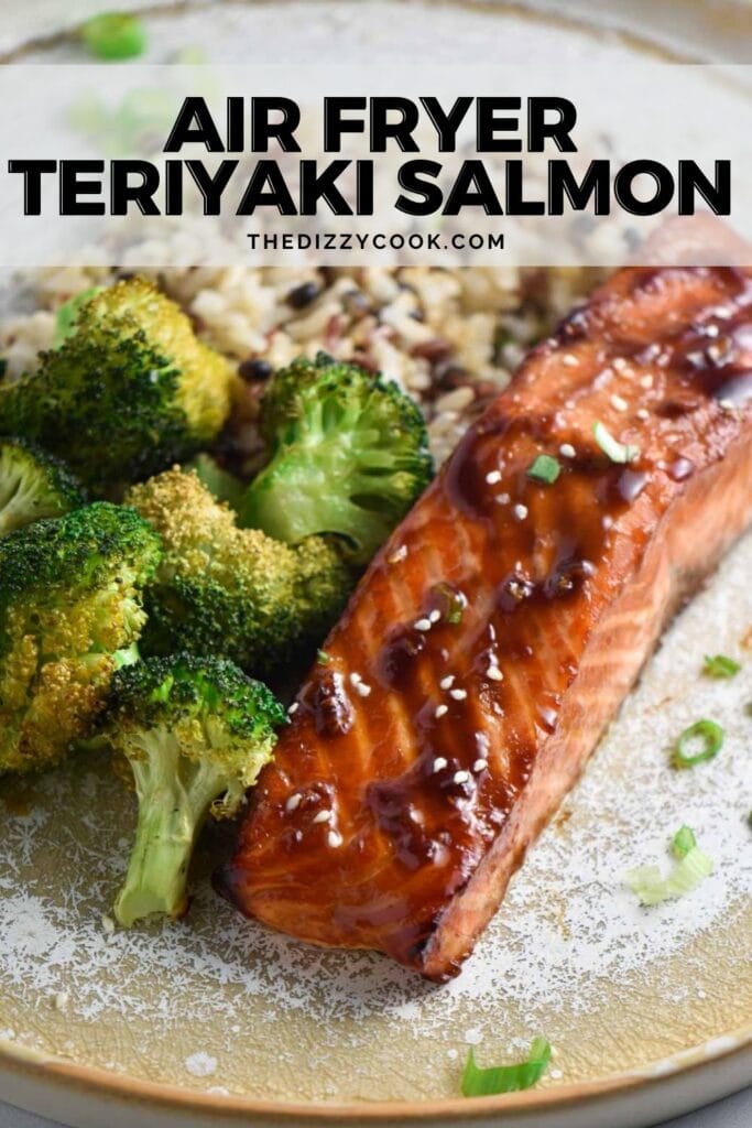 Air fried teriyaki salmon topped with a glaze and sprinkled with sesame seeds next to steamed broccoli and rice.