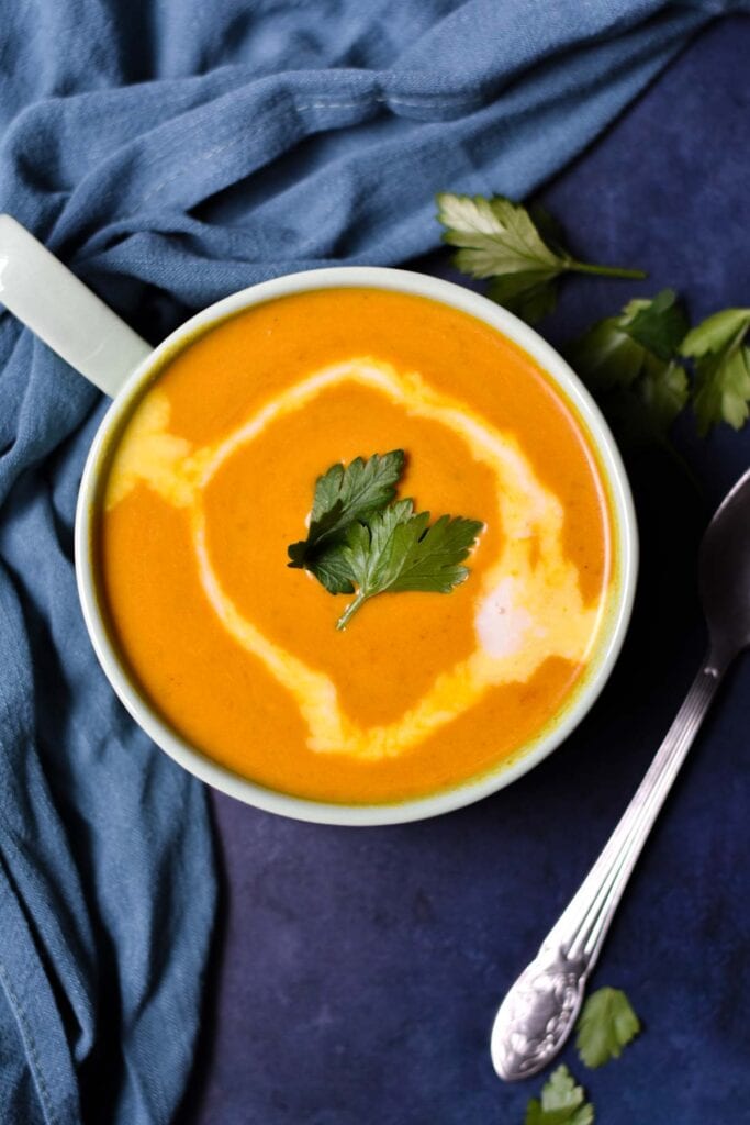 Sweet potato pepper soup topped with parsley.
