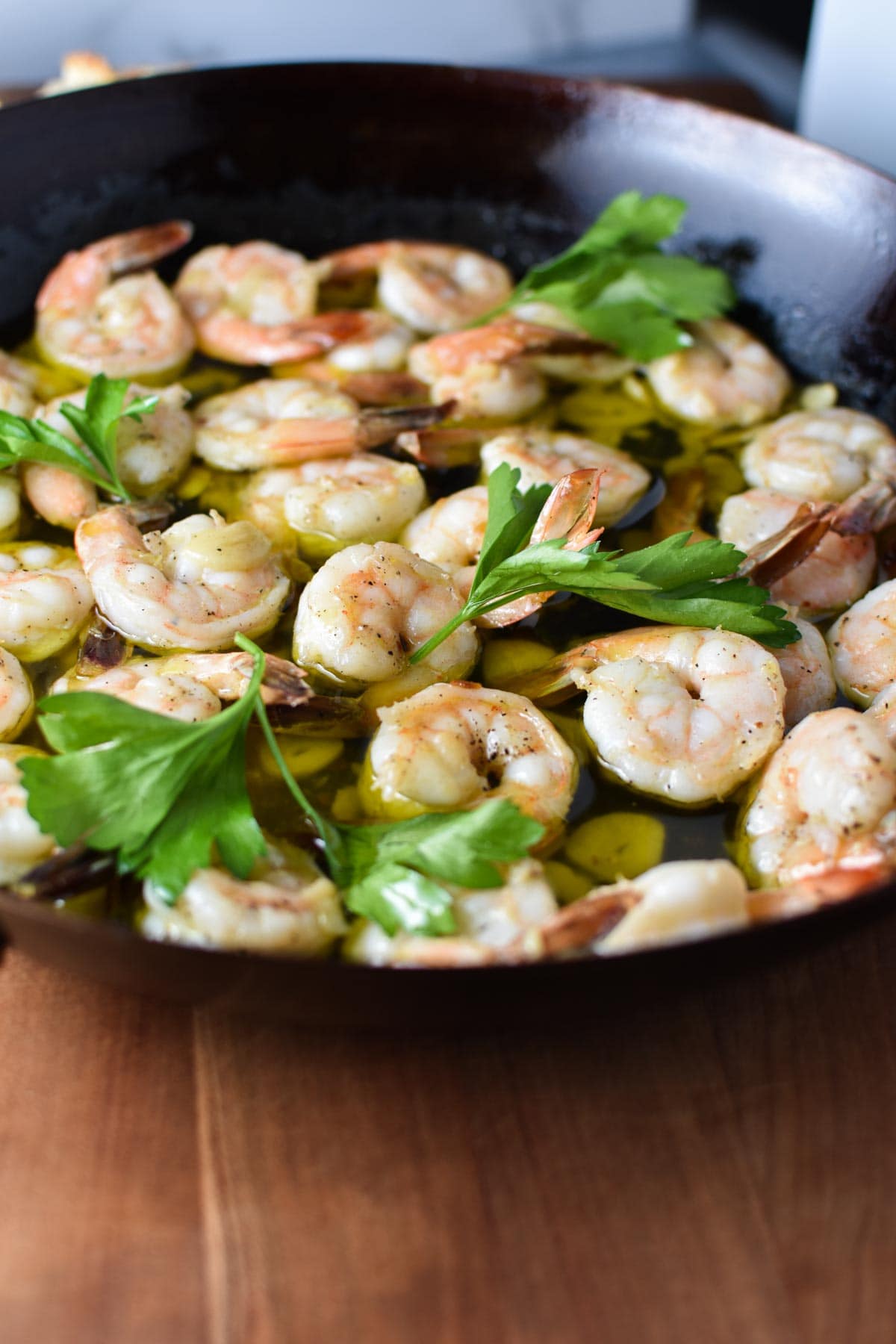 Cooked shrimp in a cast iron pan.