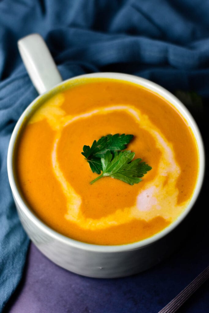 Sweet potato and red pepper soup with coconut milk on top.