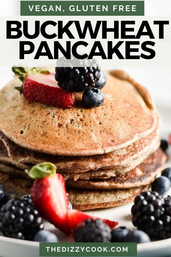A stack of vegan buckwheat pancakes with berries on top.