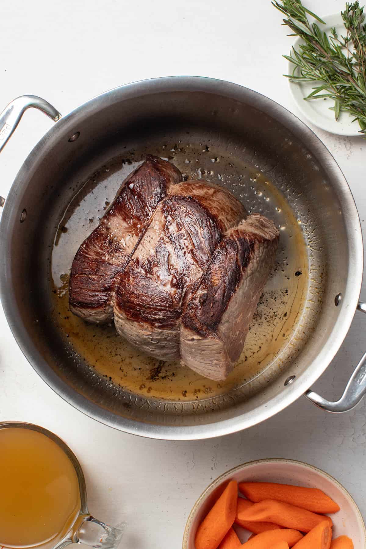 Searing the boneless chuck roast in a large dutch oven.
