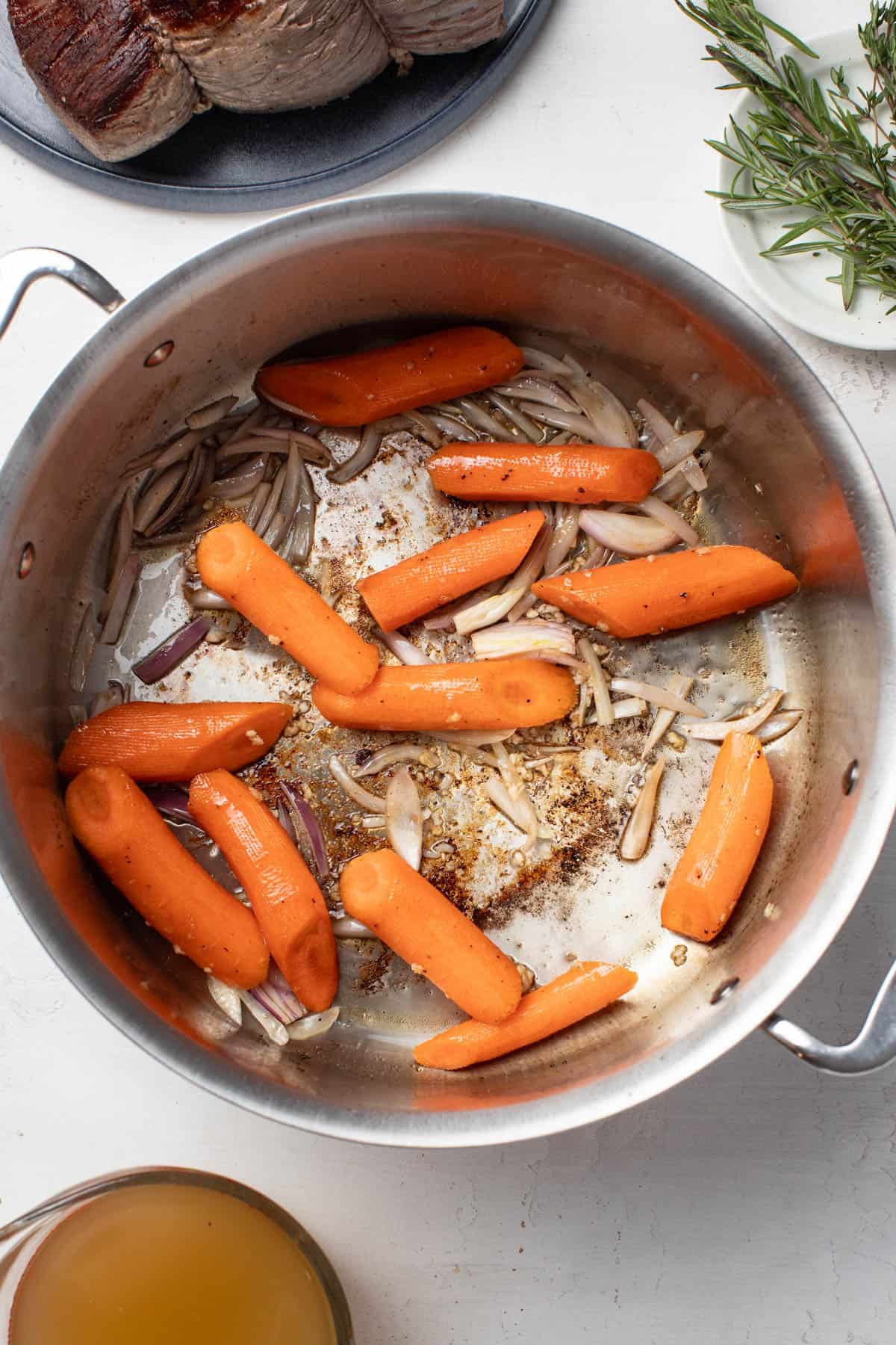 Cooking the carrots and shallots in a large dutch oven.