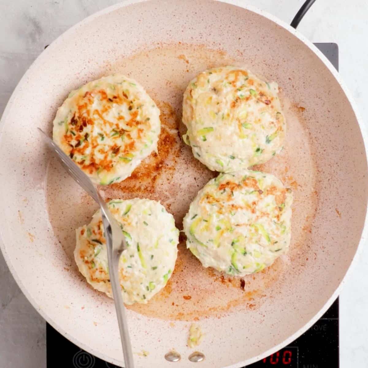 Cooking the chicken poppers in a pan till golden brown.