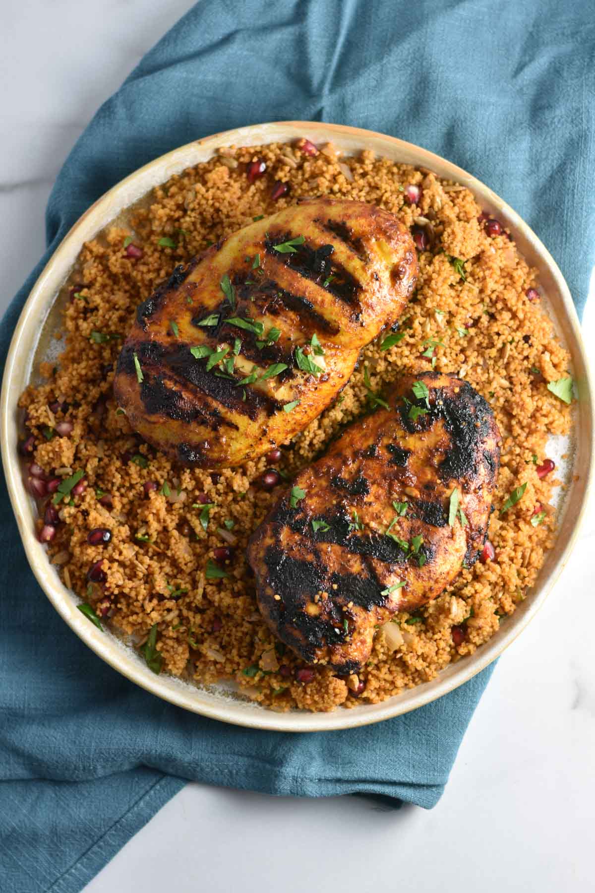 Grilled moroccan spiced chicken on a plate.