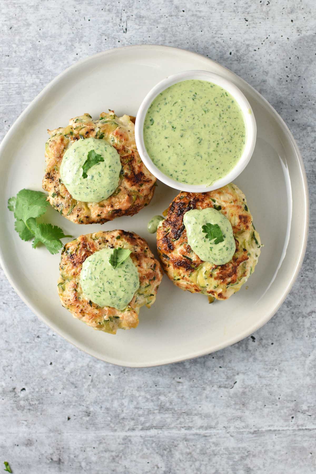 Chicken poppers topped with a creamy cilantro sauce.