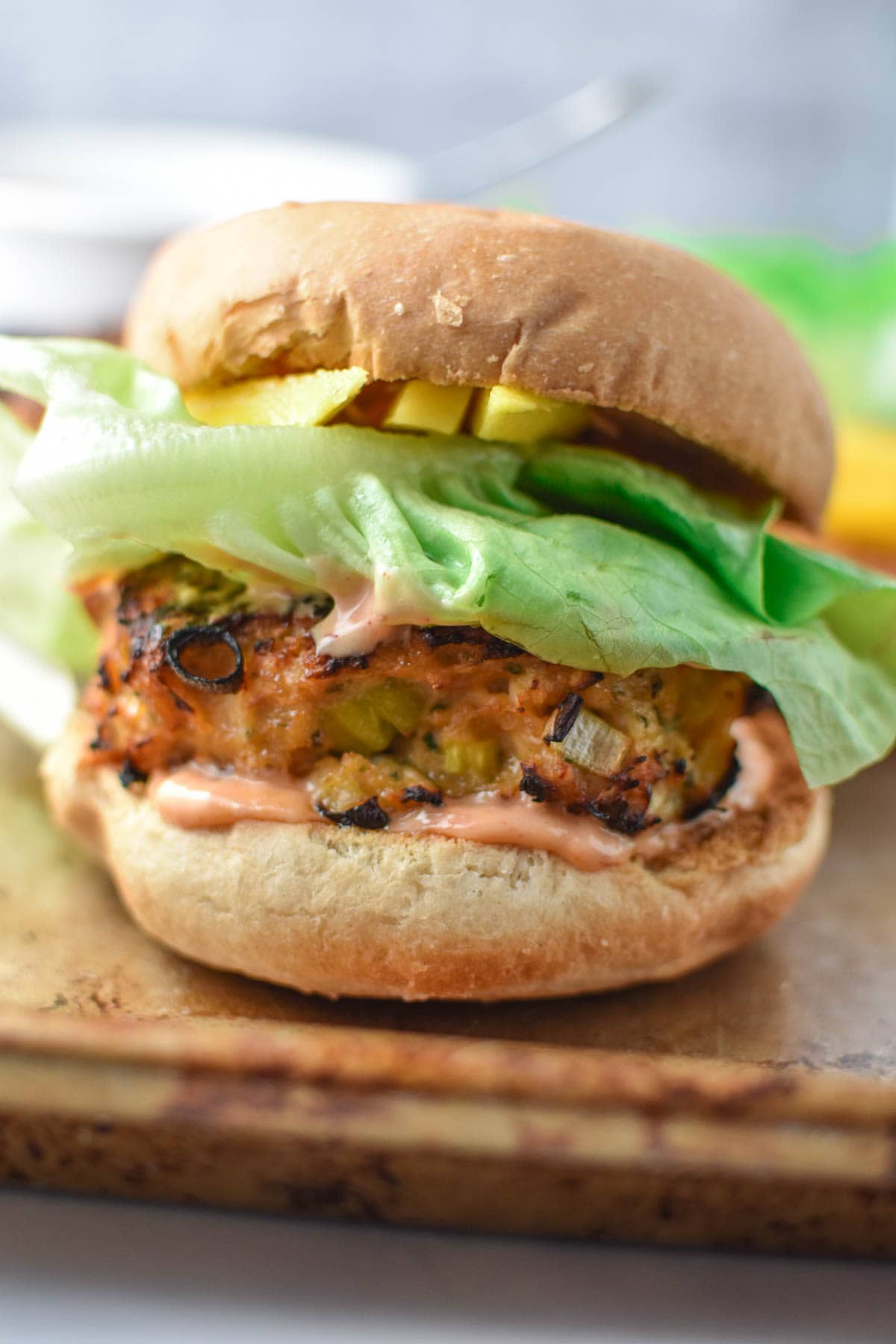A teriyaki chicken burger with butter lettuce and spicy mayo.