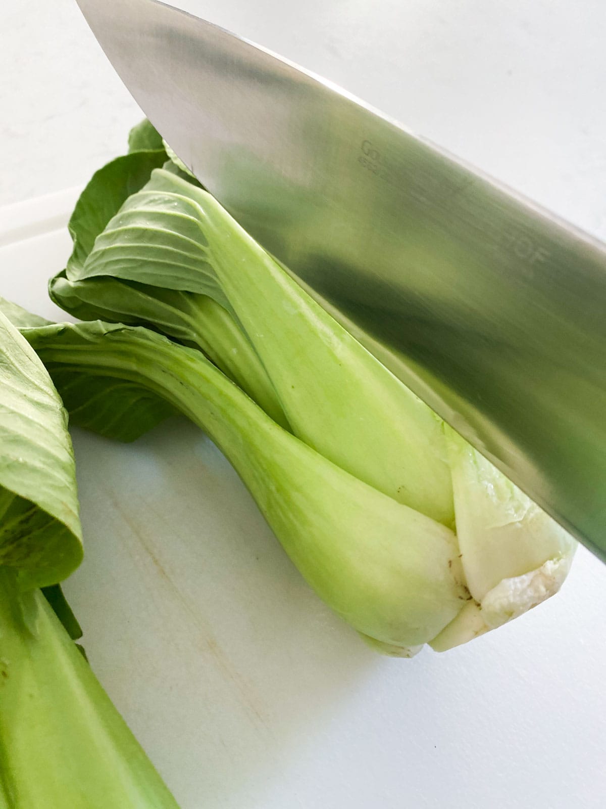 Slicing bok choy with a knife.