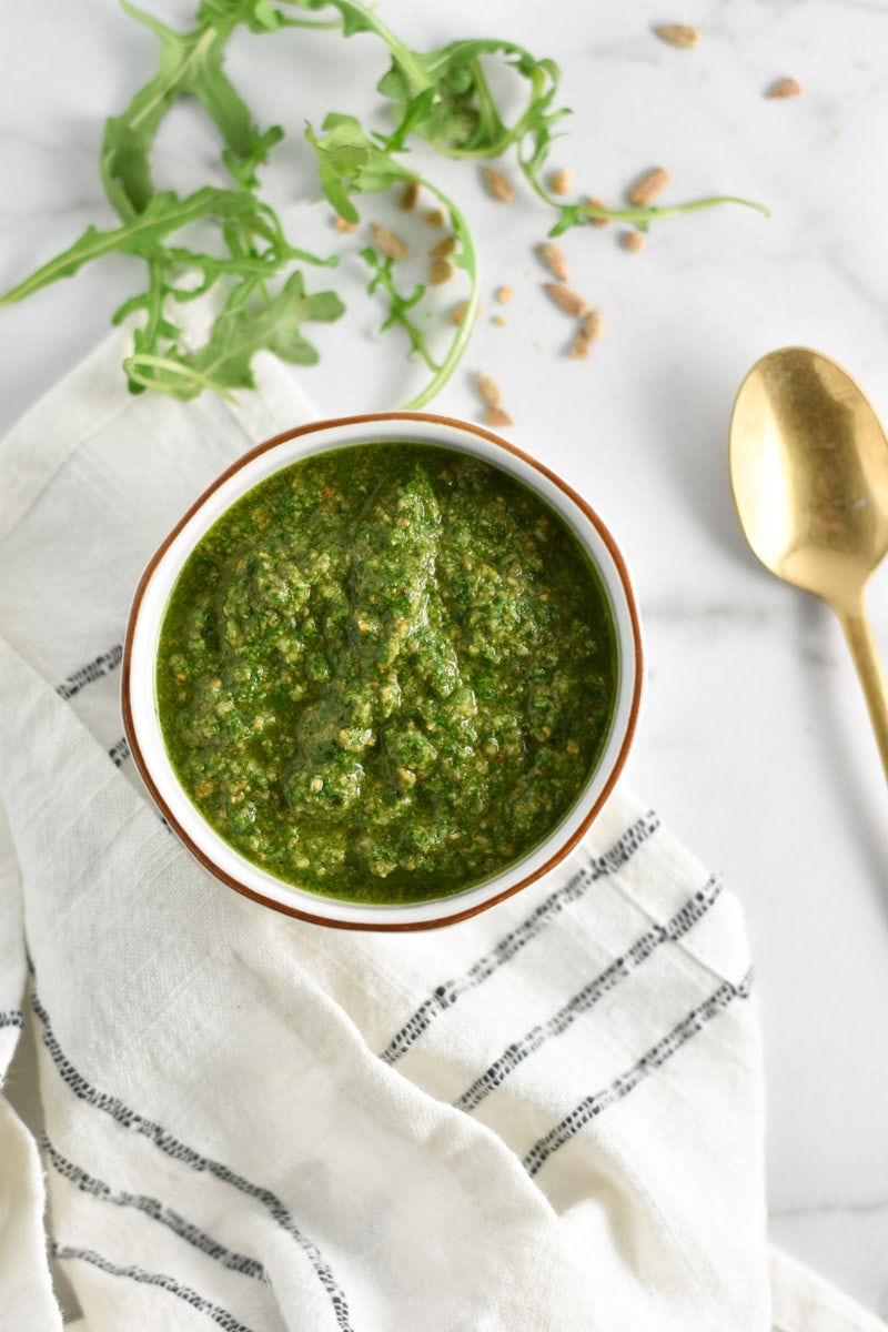 Nut free pesto next to a gold spoon.