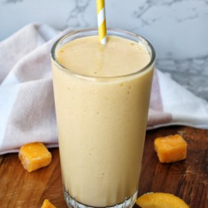 A mango smoothie with mango pieces.