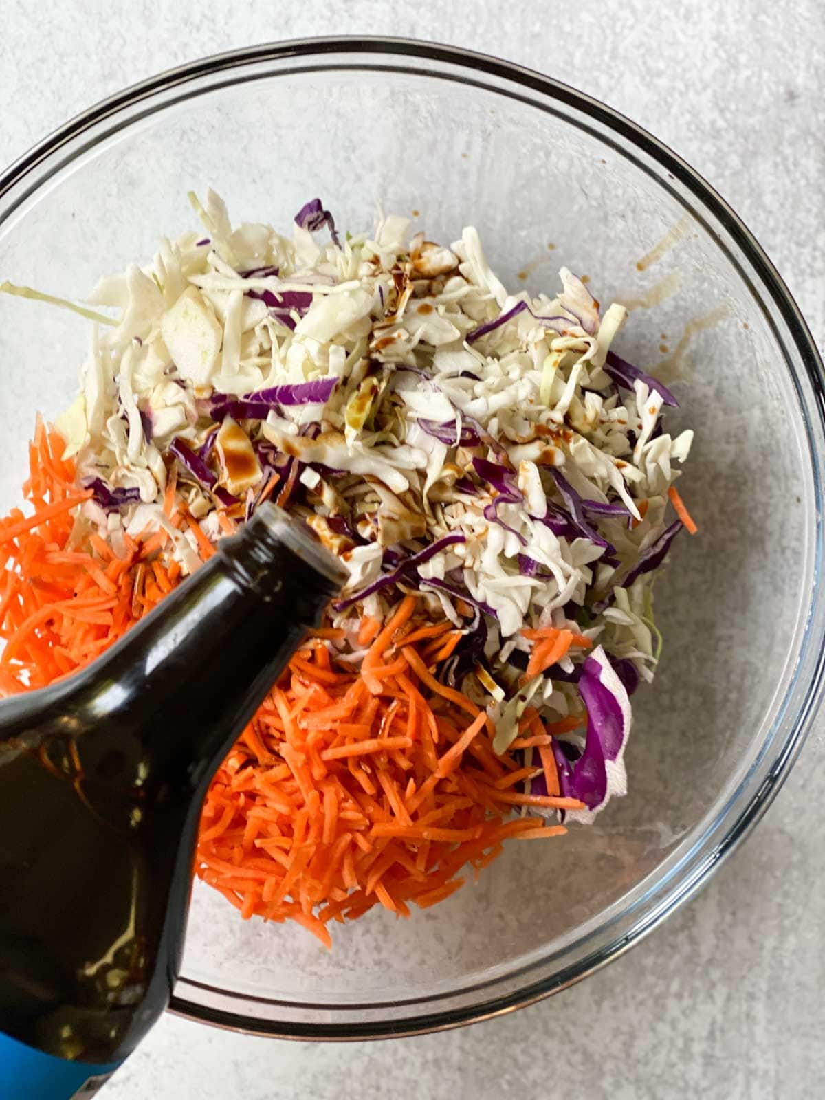 Adding coconut aminos to slaw.