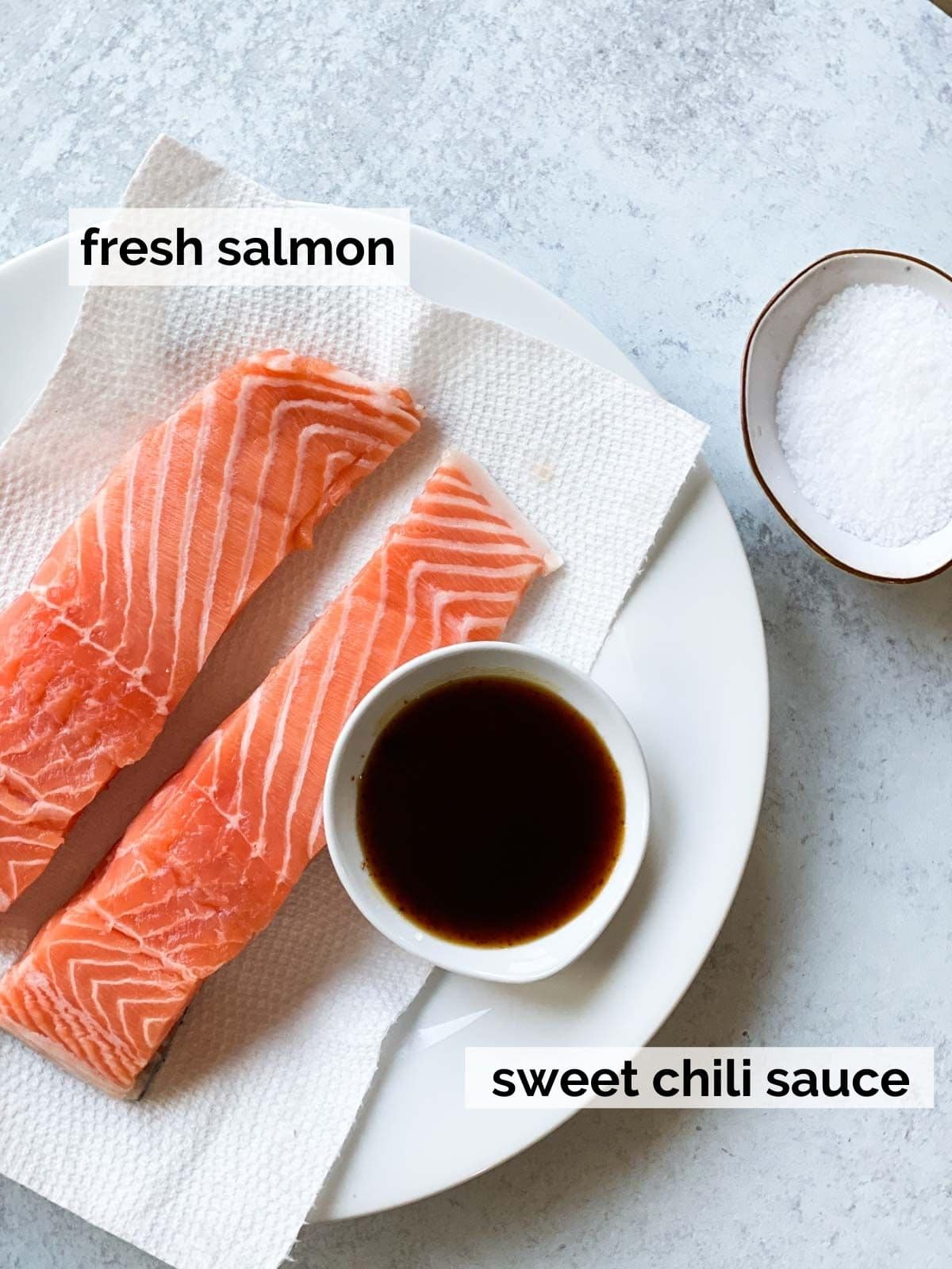 Salmon next to sweet chili sauce.