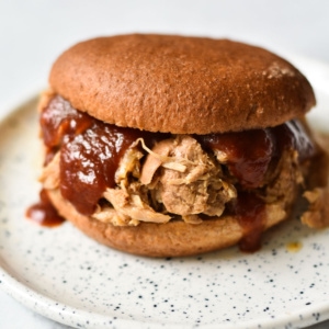 Pulled pork on a sandwich with bbq sauce.