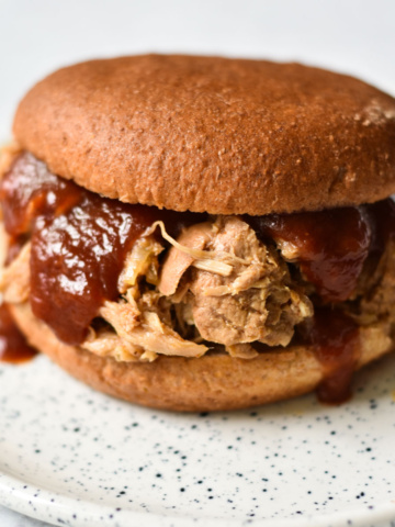 Pulled pork on a sandwich with bbq sauce.
