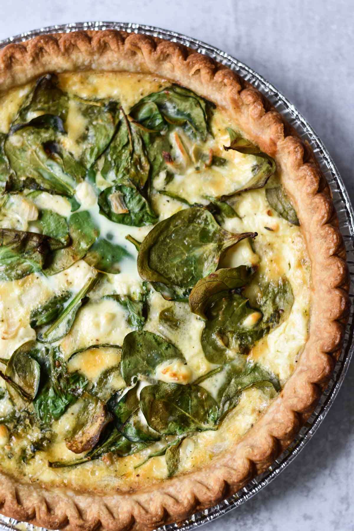 Spinach and cheese quiche on a table.