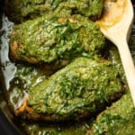 Chicken covered with pesto in the crockpot.