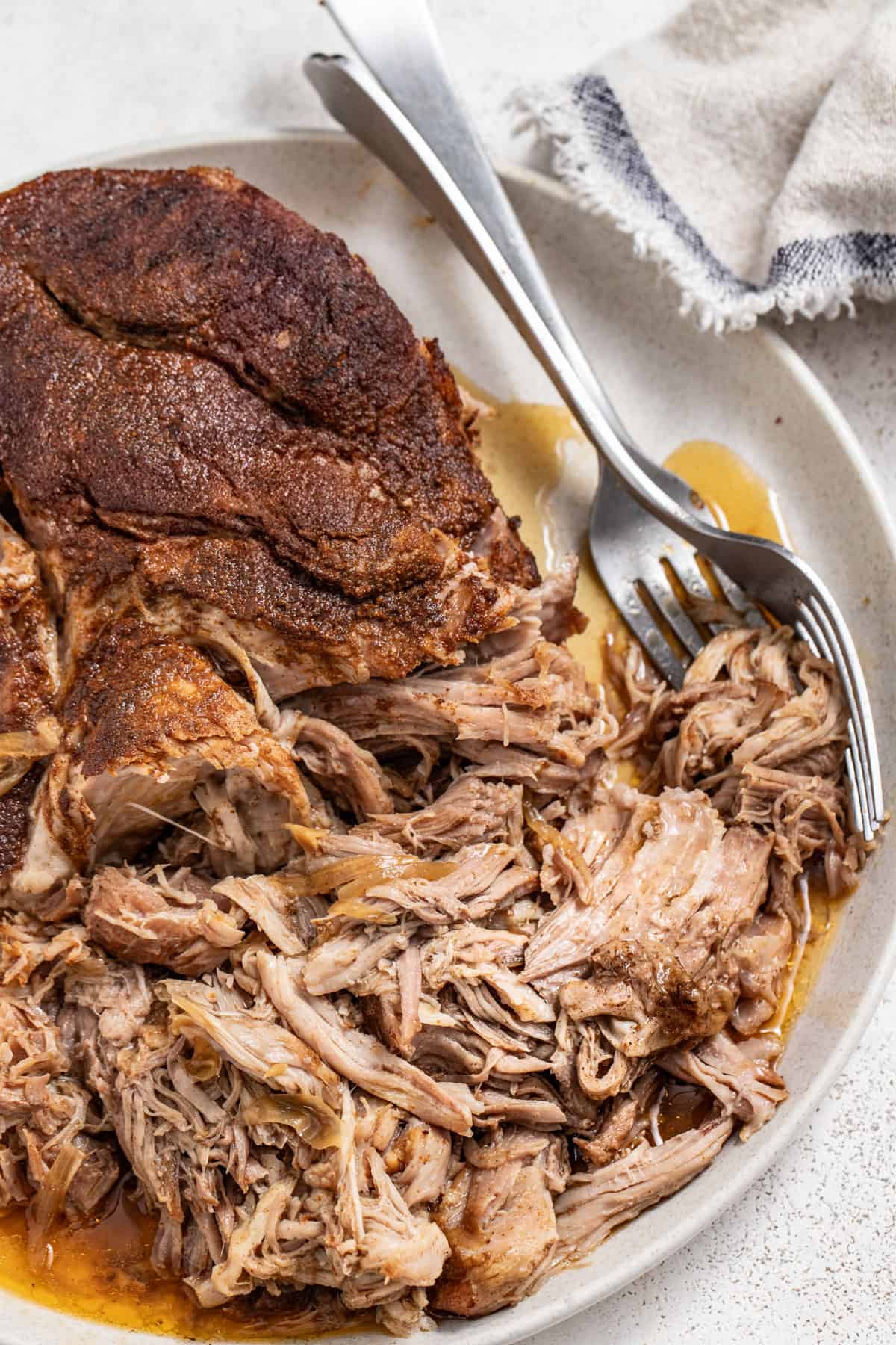 Juicy shredded pork after being slow cooked with two forks.