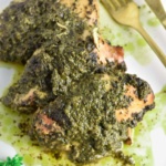 Slow cooked chicken covered in pesto sauce.