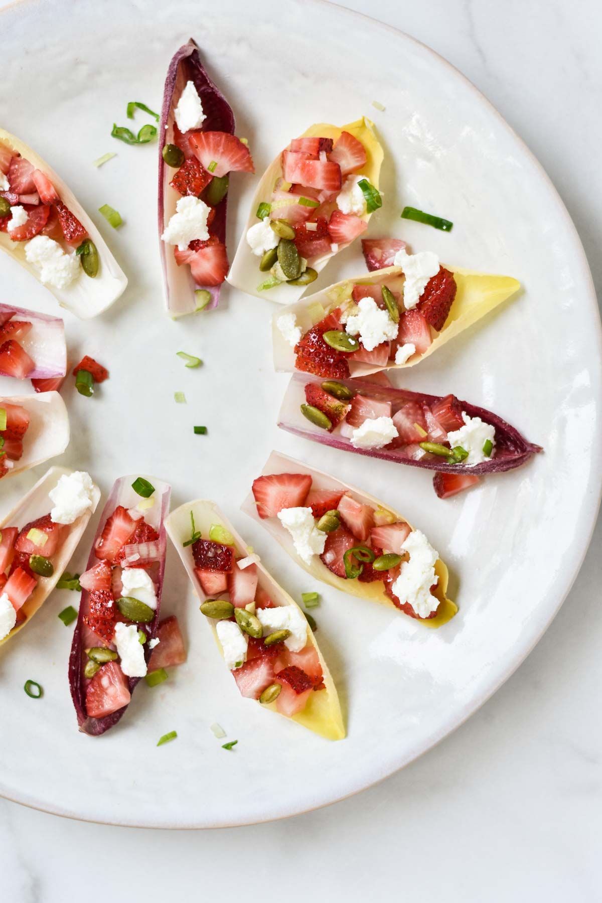 Small canapes filled with strawberries.