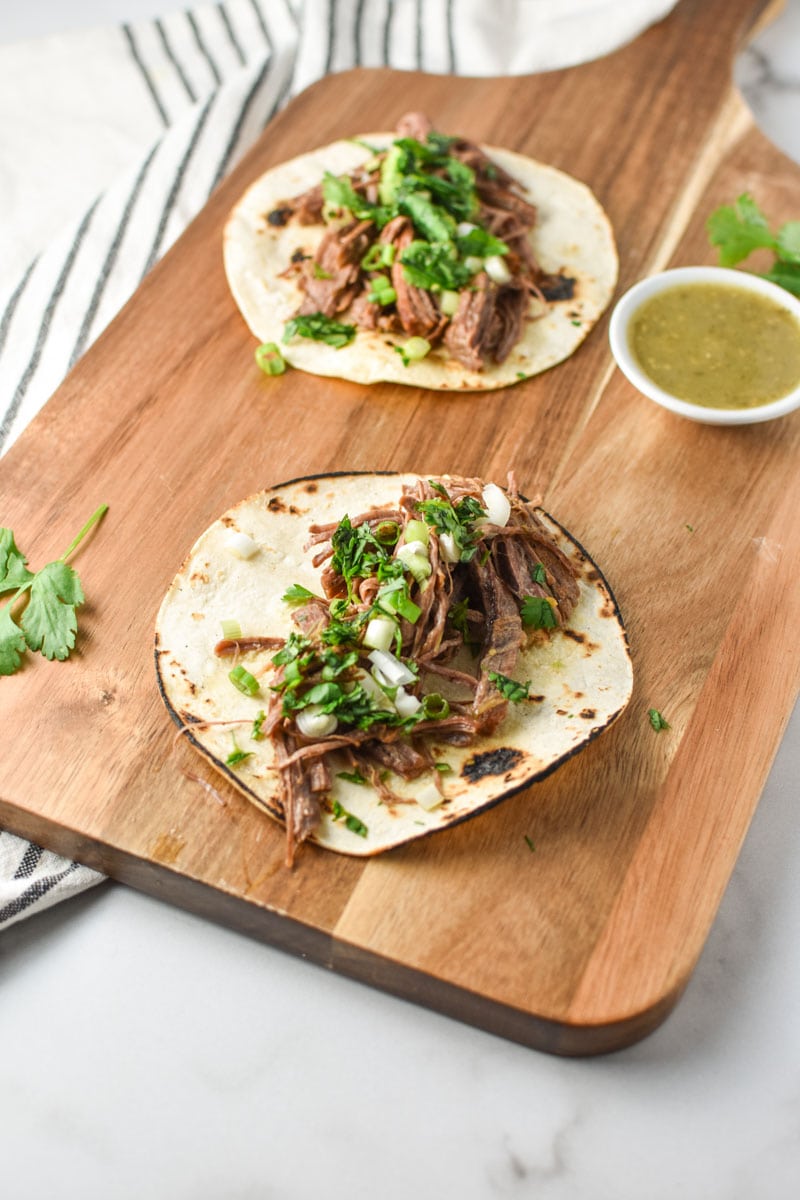 Instant pot steak tacos on a cutting board.