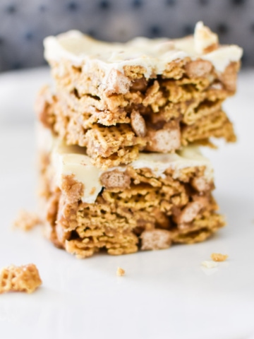 Two stacked crispy cereal bars on a plate.