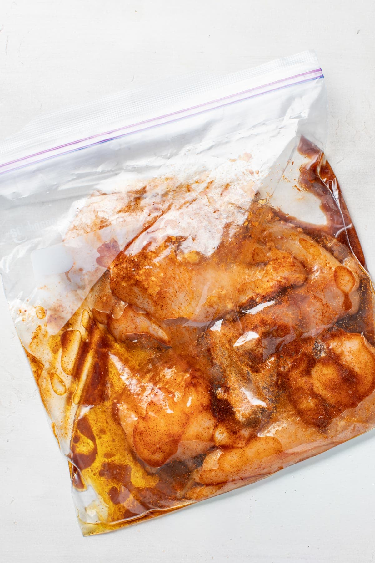 A bag filled with Mexican grilled chicken marinade and raw chicken.