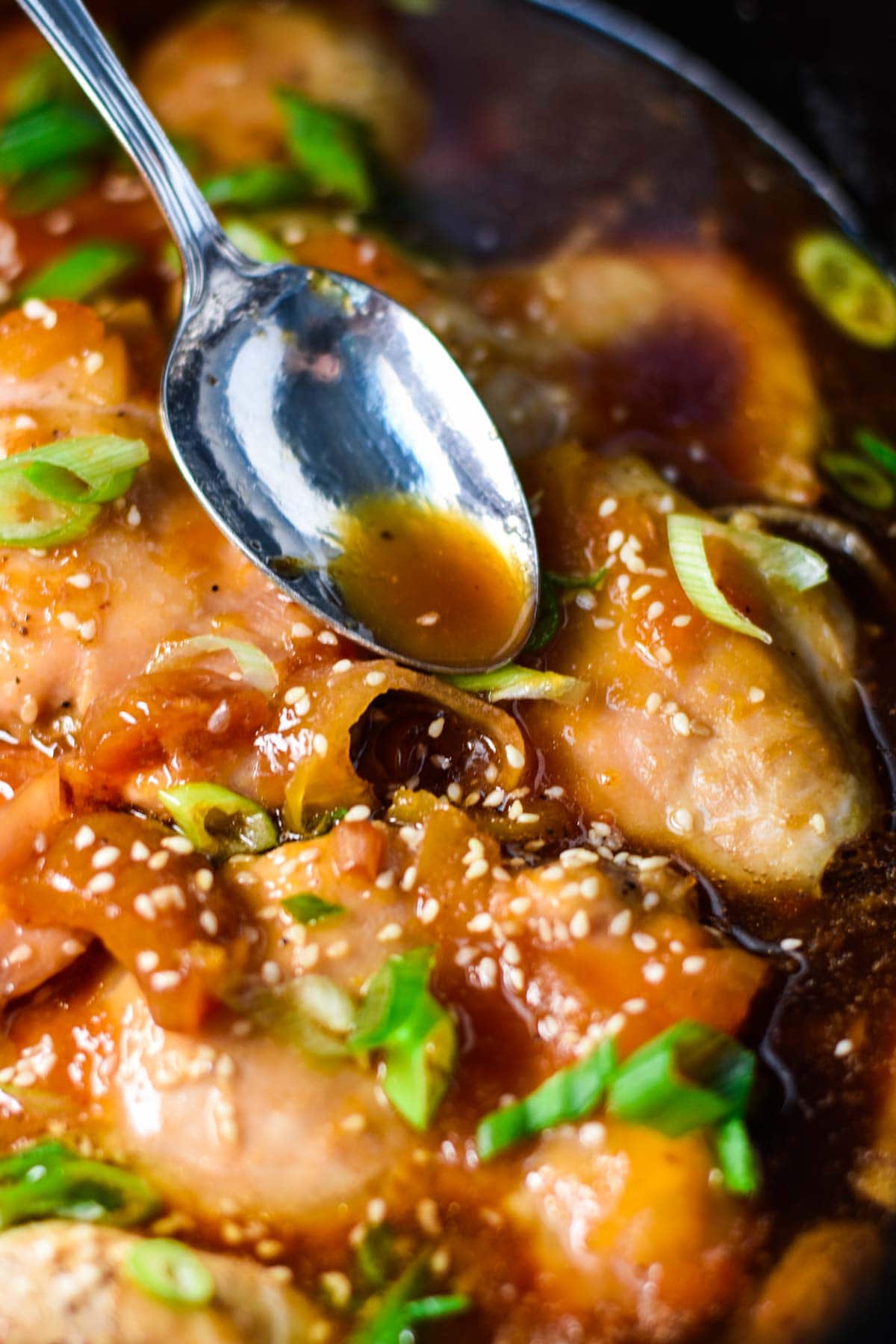 Apricot sauce poured over chicken in slow cooker.