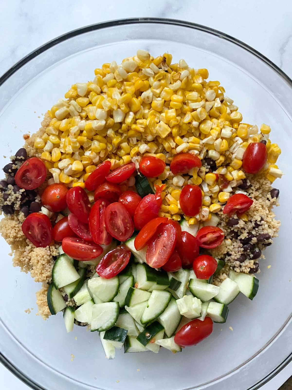 Vegetables and couscous in a mixing bowl.