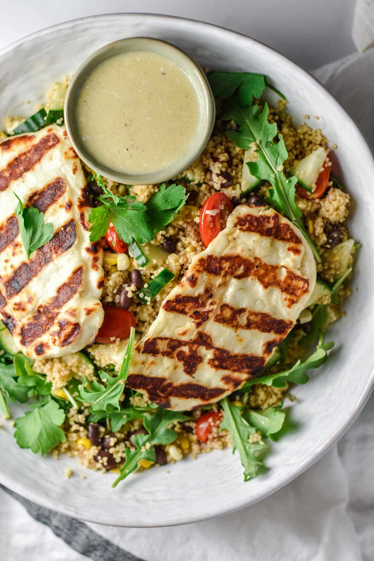 Grilled halloumi on greens with a vinaigrette dressing.
