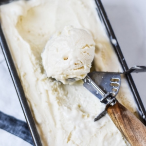 A big ice cream scoop full of mascarpone ice cream.